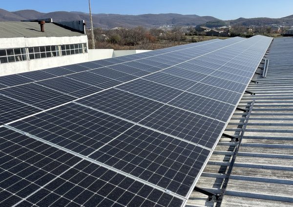 Solar panels positioned on a building's roof, contributing to eco-friendly energy generation and sustainability efforts.